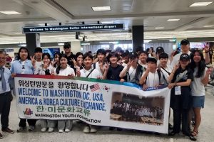 Group_of_people_at_airport_holding_banner Group_of_people_at_airport_holding_banner